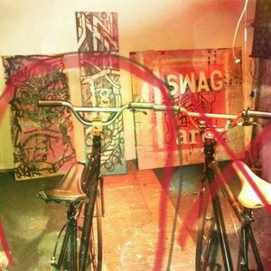 From Bikes Direct Black frame, many small white paint spots, Flip Flop with Blue/Green Handlebars now without front Wheel.  Black