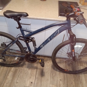 Raleigh mountain bike Blue, Silver, gray or bare metal, and Orange